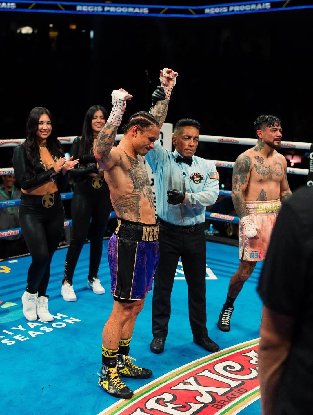 Winning boxer raising his arms while wearing black Money Socks