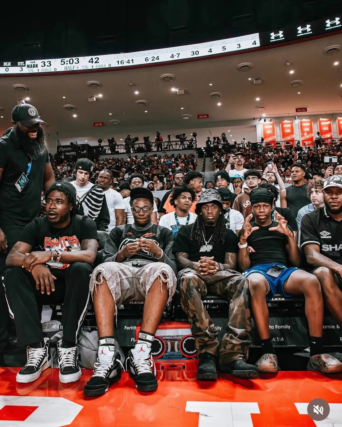 Courtside group wearing black-and-white Money Socks